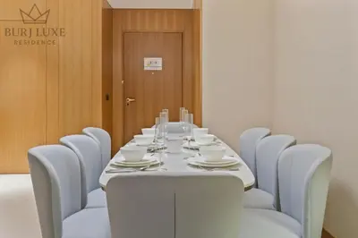 a dining room with a table and chairs at Address Residences Dubai Opera 3-bed Full Burj & Fountain View, Downtown Dubai in Dubai