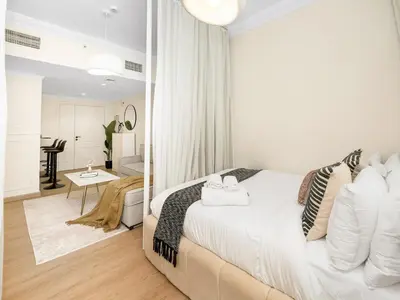a white bedroom with a bed and a living room at New Lux 3BR Apartment High Floor Prime Location BCOM in Dubai