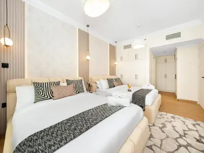 a bedroom with two beds and a couch at New Lux 3BR Apartment High Floor Prime Location BCOM in Dubai