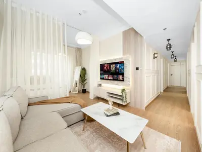a living room with a couch and a tv at New Lux 3BR Apartment High Floor Prime Location BCOM in Dubai