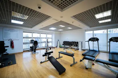 a gym with several treadmills and machines in a room at Waves - Vibrant JLT Stay - Modern Funky Studio in Dubai