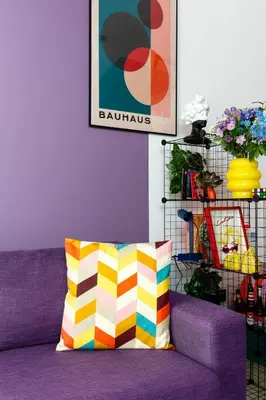 a purple couch with a colorful pillow in a room at Waves - Vibrant JLT Stay - Modern Funky Studio in Dubai
