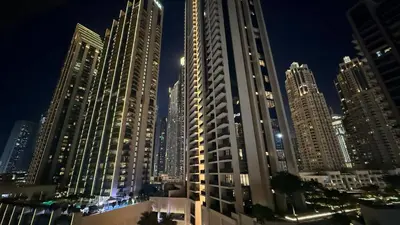 a view of a city at night with tall buildings at ASHRI HH | Elegant 2 BHK| Downtown Dubai | 8Blvd in Dubai