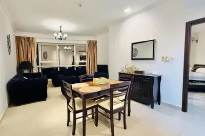 a living room with a table and a couch at Cosy 1 Bed in JLT in Dubai