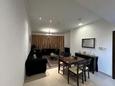 a living room with a table and a couch at Cosy 1 Bed in JLT in Dubai