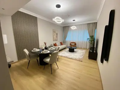 a living room with a table and a couch at Comfy 1 Bedroom in Dubai Marina in Dubai