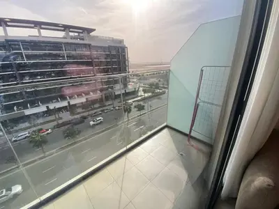 a view of a city street from a window at Large 1 Bedroom Apartment in Azizi Riviera 15 in Dubai