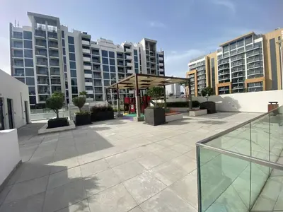 a patio in a city with tall buildings at Large 1 Bedroom Apartment in Azizi Riviera 15 in Dubai