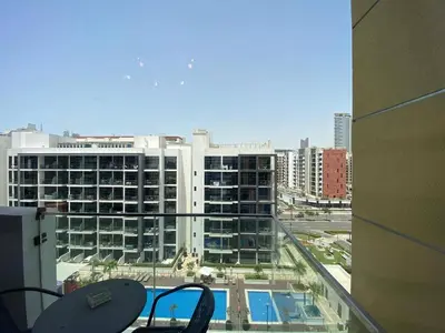 a view of a large building from a balcony at Modern Studio with Balcony - Pool View in Dubai
