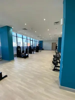 a large empty room with chairs and blue walls at Bright Studio - Azizi Riviera 35 - Fully Furnished in Dubai