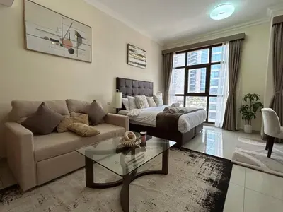 a living room with a couch and a coffee table at Modern Studio - Lincoln Park West - Dubai, Arjan in Dubai