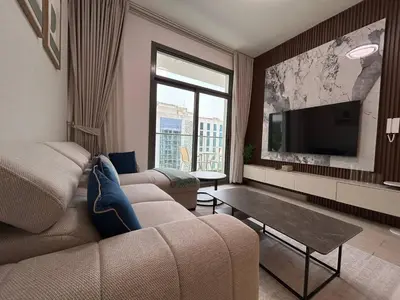 a living room with a couch and a flat screen tv at Stylish 1-Bed Apartment in Laya Heights, Dubai in Dubai
