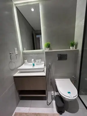 a bathroom with a sink and a mirror and a toilet at Stylish 1-Bed Apartment in Laya Heights, Dubai in Dubai