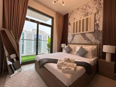 a bedroom with a large bed with a large window at Stylish 1-Bed Apartment in Laya Heights, Dubai in Dubai