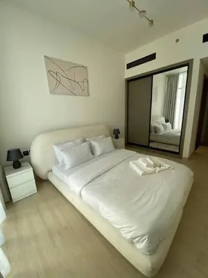 a bedroom with a large white bed and a large mirror at 1-Bedroom in Binghatti Emerald 1 with free Pool and Gym in Dubai