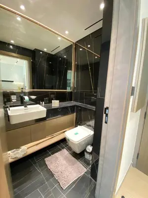 a bathroom with a sink and a toilet at 1-Bedroom in Binghatti Emerald 1 with free Pool and Gym in Dubai