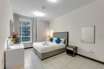 a bedroom with a large bed and a window at Luxury 2BR Escape - Durar 1B 2, Wadi Al Safa in Dubai