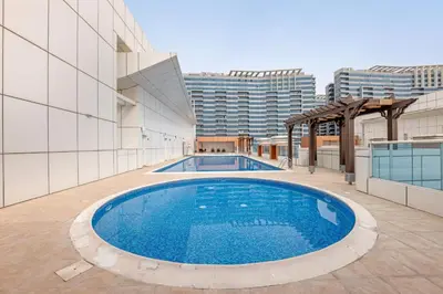 a swimming pool on the roof of a building at Luxury 2BR Escape - Durar 1B 2, Wadi Al Safa in Dubai