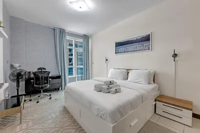 a bedroom with a bed with a teddy bear on it at Luxury 2BR Escape - Durar 1B 2, Wadi Al Safa in Dubai