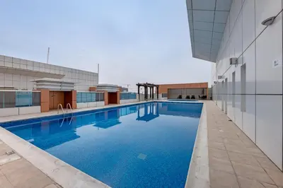 a swimming pool in the middle of a building at Luxury 2BR Escape - Durar 1B 2, Wadi Al Safa in Dubai