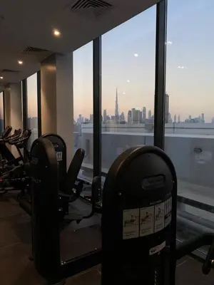 a gym with chairs and a view of a city at Modern Studio in Azizi Riviera 10, Near Downtown in Dubai