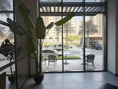 a potted plant in a room with a window at ASHRI HH | Elegant Studio | UNA Townsquare in Dubai