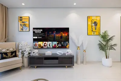 a living room with a tv on the wall at Burj Khalifa View II Luxury HIGH Floor whith Pool&Spa in Dubai