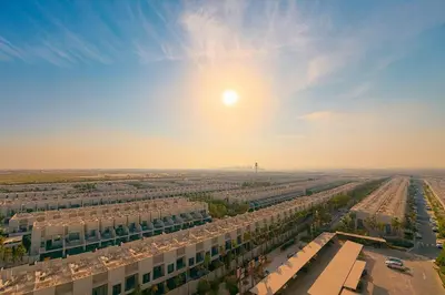 an aerial view of a building with the sun in the sky at Designer Studio near Downtown & Dubai Mall in Dubai