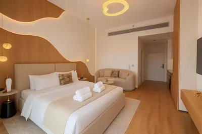 a hotel room with a bed and a couch at Designer Studio near Downtown & Dubai Mall in Dubai