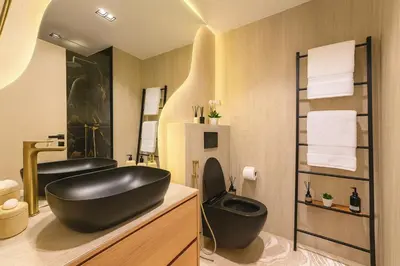 a bathroom with a black tub and a sink at Designer Studio near Downtown & Dubai Mall in Dubai