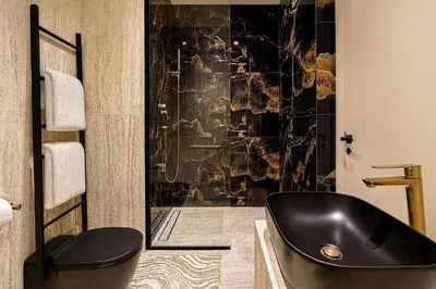 a bathroom with a black tub in a room at Designer Studio near Downtown & Dubai Mall in Dubai