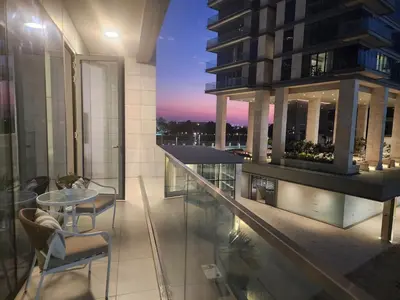 a balcony of a building with a table and chairs at SOLARTE Luxe - NEW Canal Front Residence - Pool with Burj Views in Dubai
