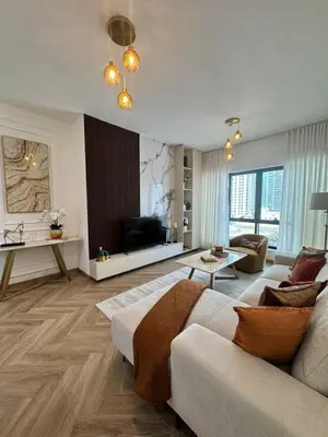 a large living room with a couch and a tv at Stylish 1BR in Dubai Marina,Walk to JBR in Dubai