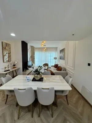 a dining room and living room with a table and chairs at Stylish 1BR in Dubai Marina,Walk to JBR in Dubai