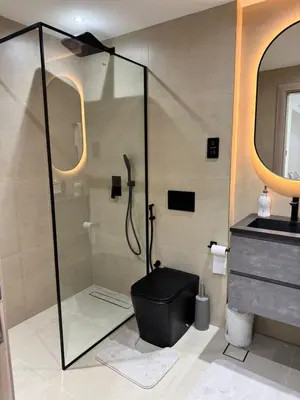 a bathroom with a shower and a black toilet at Stylish 1BR in Dubai Marina,Walk to JBR in Dubai