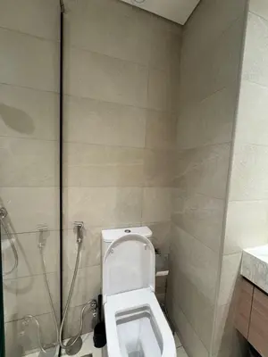 a bathroom with a toilet and a shower at Azizi Riviera 41 - Meydan by Golden Casa in Dubai