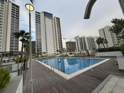 a swimming pool in a city with tall buildings at Azizi Riviera 41 - Meydan by Golden Casa in Dubai