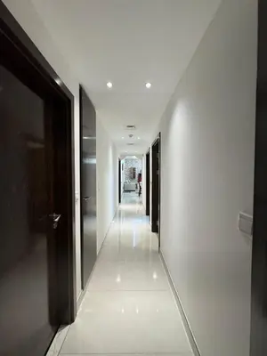 a hallway of a building with white walls and ceilings at Spacious 3BR Apartment Family Friendly Community in Dubai