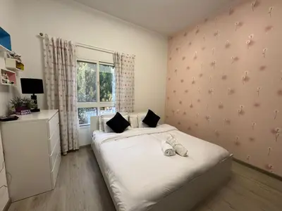 a bedroom with a white bed and a window at Spacious 3BR Apartment Family Friendly Community in Dubai