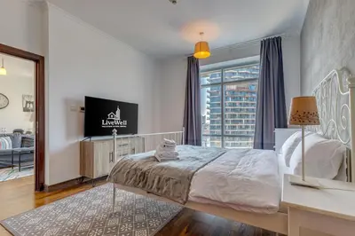 a bedroom with a bed and a large window at Burj Views Tower, 1 Bdr Apartment with Opera View in Dubai