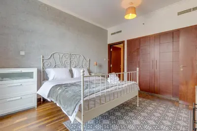 a bedroom with a bed and a dresser at Burj Views Tower, 1 Bdr Apartment with Opera View in Dubai