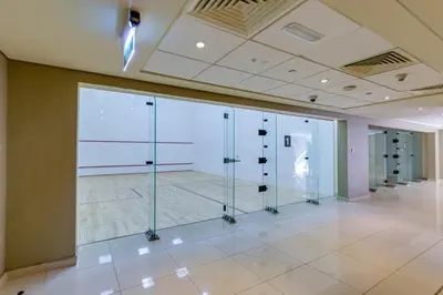 a room with glass doors in a building at Burj Views Tower, 1 Bdr Apartment with Opera View in Dubai