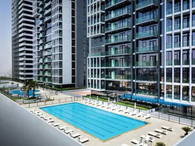 an overhead view of a swimming pool in front of tall buildings at Stylish & Peaceful 2BR Home in JVC District in Dubai