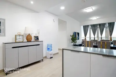 a kitchen with white walls and a counter top at Stylish & Peaceful 2BR Home in JVC District in Dubai