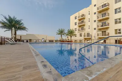 a large swimming pool in front of a building at Remraam, 1 Bedroom in Al Ramth 11 - Allsopp & Allsopp in Dubai