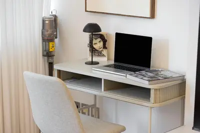 a desk with a laptop and a lamp on it at DIFC Sky Gardens Studio In front of DIFC Gate in Dubai