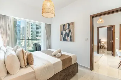 a bedroom with a large bed and a large window at RH - Burj Khalifa view with large balcony, 02BR retreat in business bay in Dubai