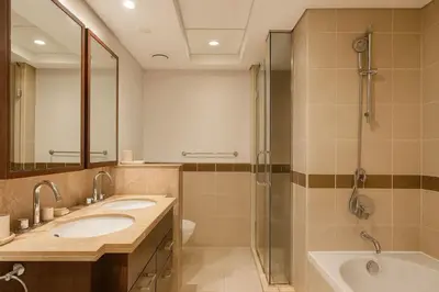 a bathroom with two sinks and a shower at Vacay Lettings 1 bed with burj Khalifa View in Dubai