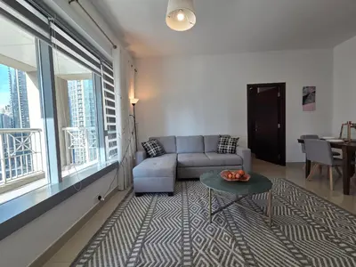 a living room with a couch and a table at Vacay Lettings 1 bed with burj Khalifa View in Dubai