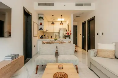 a living room with a couch and a table at Gardenia Living 204 in Dubai